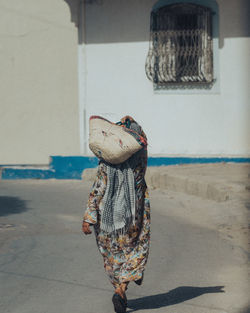 Rear view of person walking on street