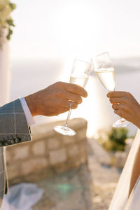 Cropped hand of woman holding drink at home