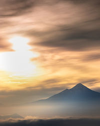 Scenic view of snowcapped mountains against sky during sunset