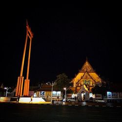 Illuminated statue against sky at night