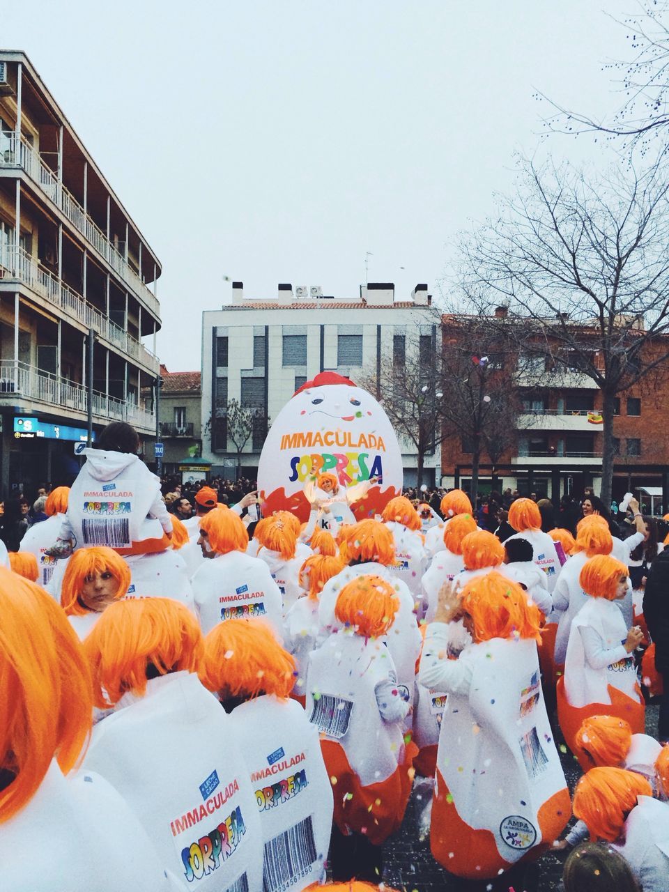 building exterior, architecture, built structure, clear sky, city, sky, food and drink, orange color, outdoors, day, men, art and craft, lifestyles, human representation, art, street, incidental people, food