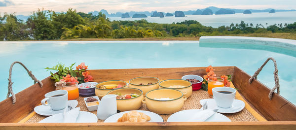 High angle view of breakfast on table at swimming pool