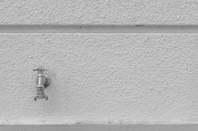 Full frame shot of faucet at wall