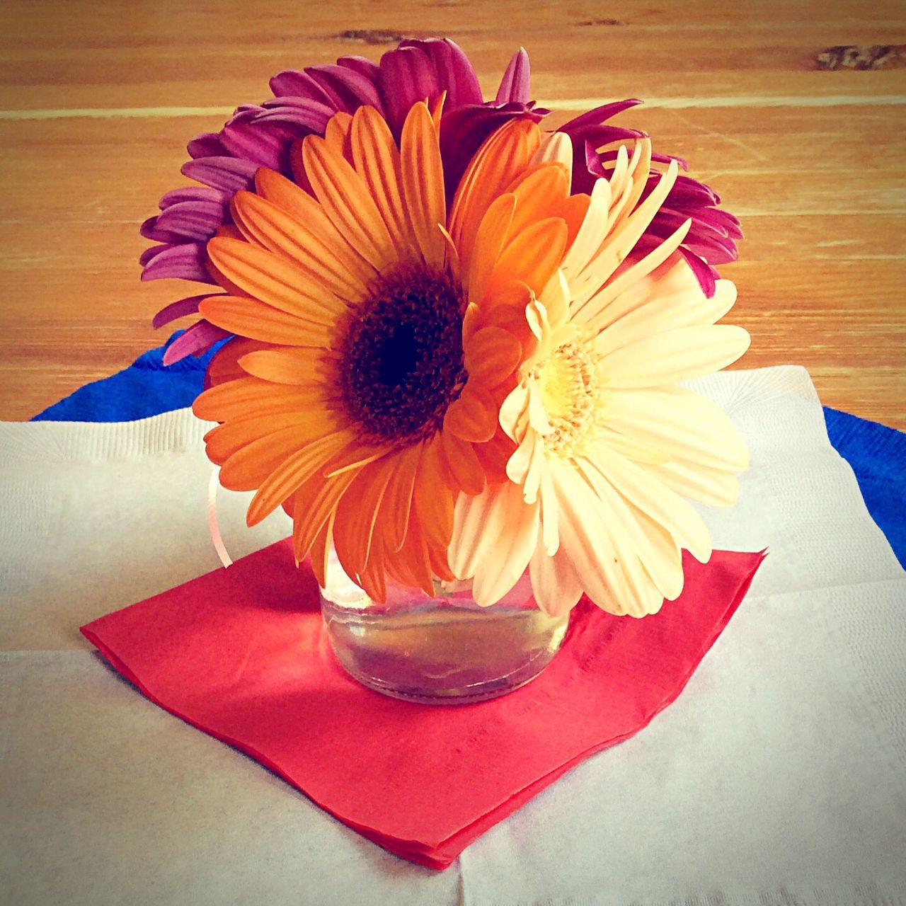 indoors, table, still life, flower, freshness, vase, decoration, high angle view, petal, close-up, wood - material, flower head, no people, directly above, home interior, multi colored, art and craft, fragility, design, floral pattern