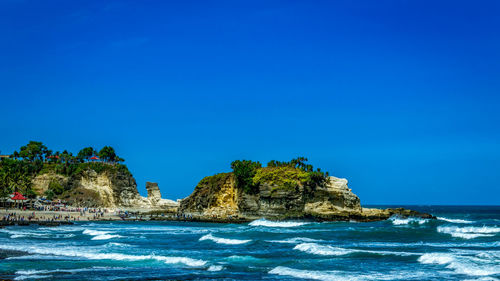 Scenic view of sea against clear blue sky