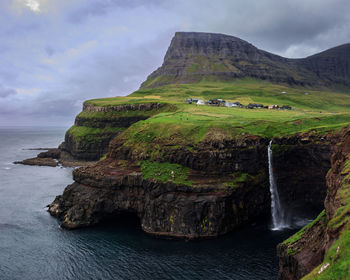 Scenic view of sea against rock formation