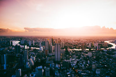 High angle view of modern buildings against sky during sunset