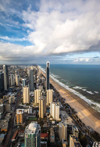 High angle view of buildings by sea against sky