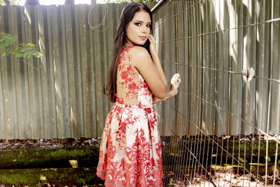 Portrait of beautiful young woman standing outdoors