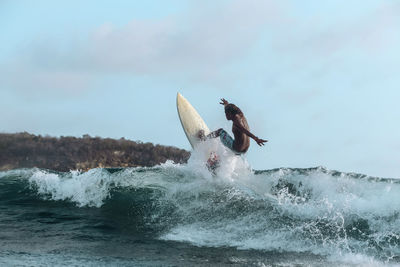 Surfer on a wave, lombok, indonesia