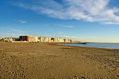 View of beach against cloudy sky