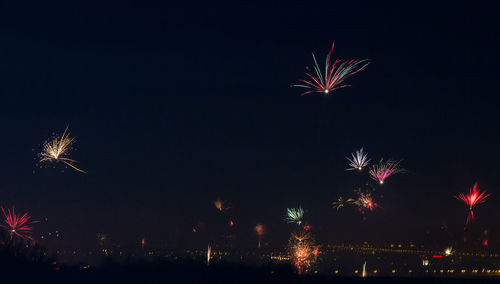 Low angle view of firework display at night