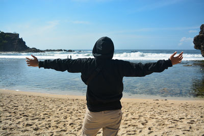Full length of man standing on beach