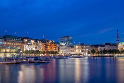 Illuminated buildings in city at waterfront