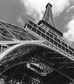 Low angle view of bridge against cloudy sky