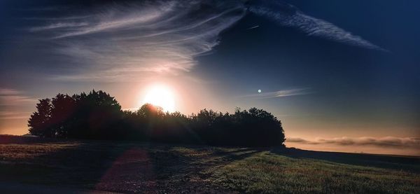 Scenic view of field against sky during sunset