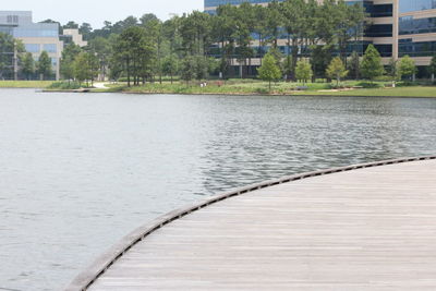 Scenic view of river by city against sky