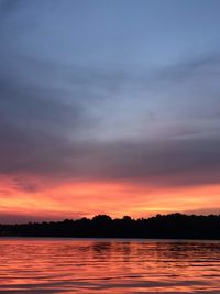 Scenic view of lake against romantic sky at sunset