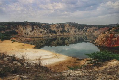 Scenic view of lake and mountains against sky