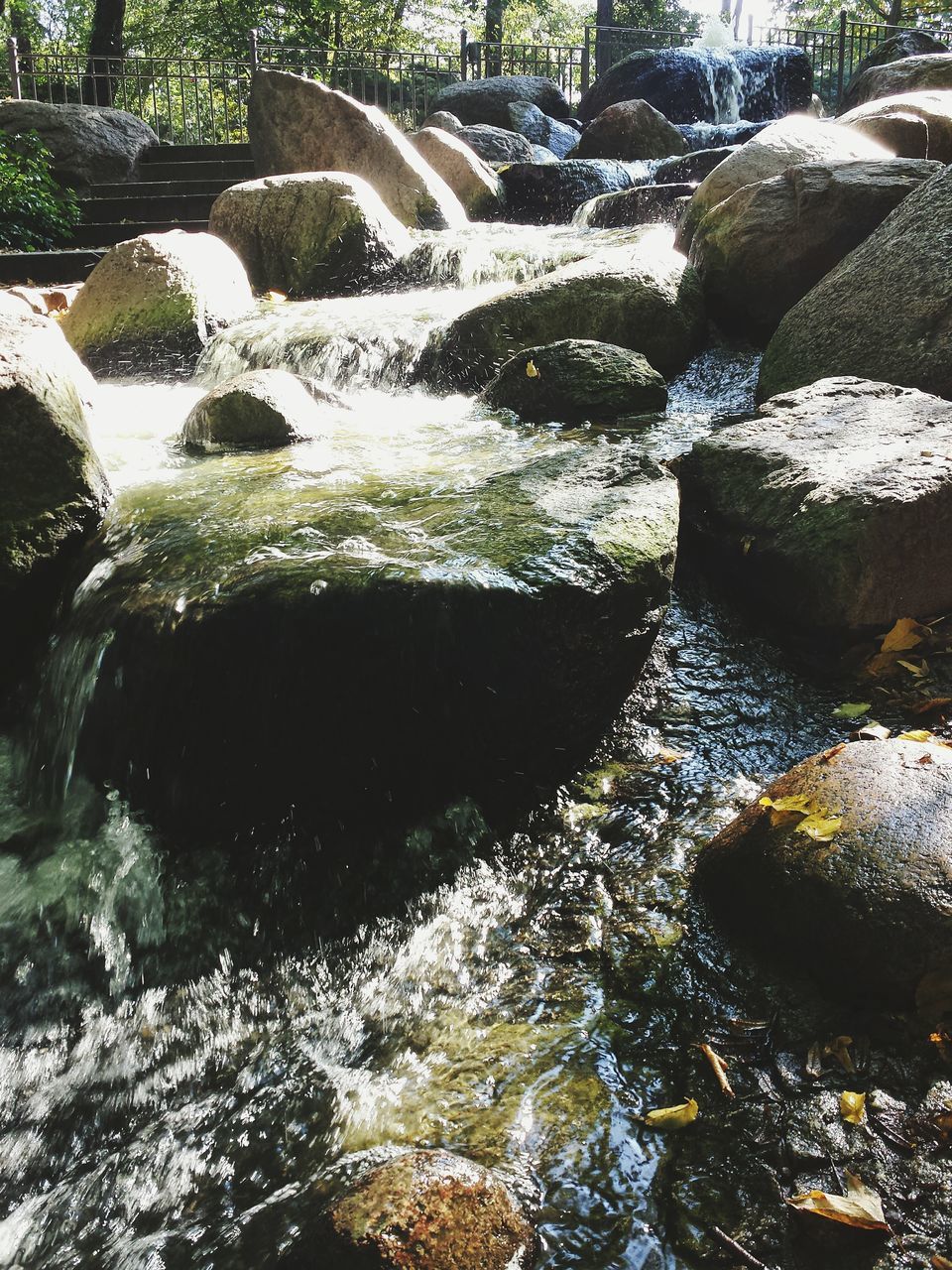 STREAM FLOWING THROUGH ROCKS