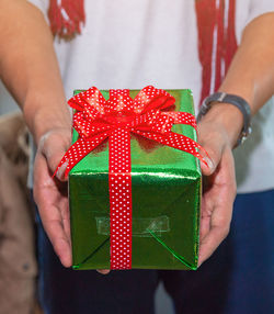 Midsection of man holding gift box