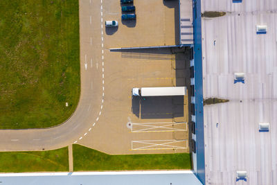 Aerial top view of the large logistics park with warehouse, loading hub with many semi-trailers .