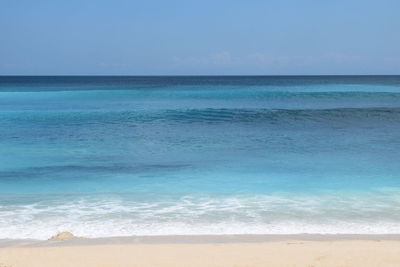 Calm ocean waves at sandy beach