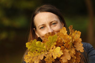 Portrait of woman with yellow leaves