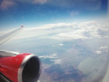 Distant view of airplane wing over sea