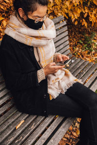 Low section of woman sitting outdoors