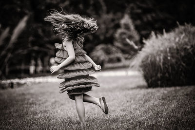 Woman with umbrella on field