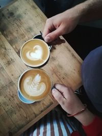 Cropped image of hand holding coffee cup