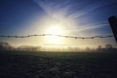 Scenic view of field against sky during sunset