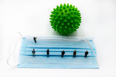 Close-up of people with ball against white background