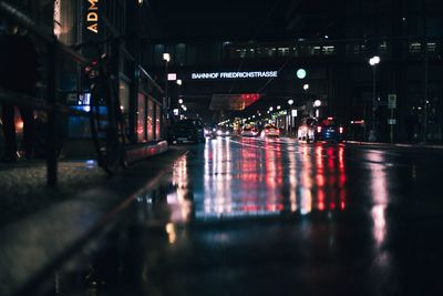 Surface level of wet city street at night