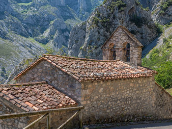 Stone wall of building with mountain in background