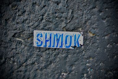 Close-up of information sign on wall