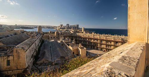 Panoramic view of sea and city against sky