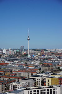 Buildings in city against clear sky