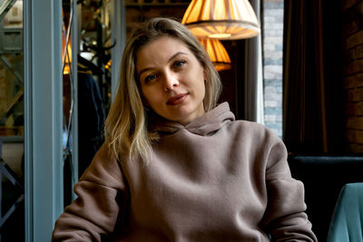 Portrait of young woman sitting in bus