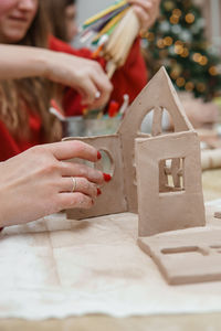 Women's hands knead clay, drawing elements of the product. production of ceramic products