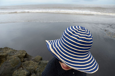 Woman in hat against sea