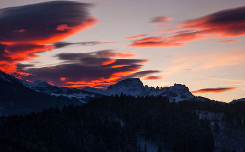 Scenic view of mountains against orange sky