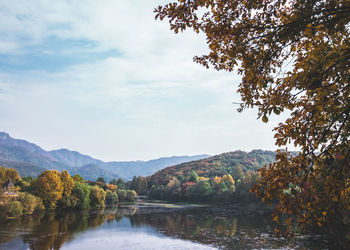 Scenic view of lake amidst trees against sky during autumn