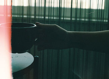 Close-up of hand holding coffee cup