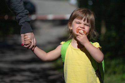 Full length of happy girl standing outdoors