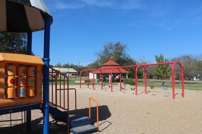 Empty playground against blue sky