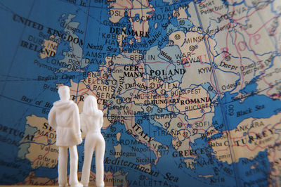 Figurines standing in front of world map