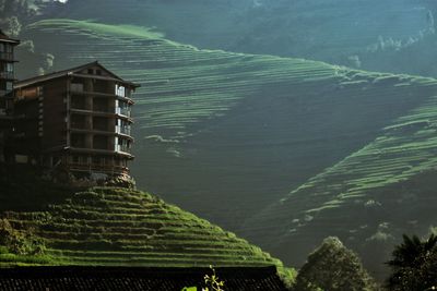 Cottage against mountains in sunny day