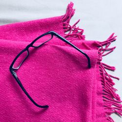 High angle view of black painting on pink over white background